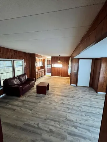 a spacious bedroom with a bed a couch and dresser