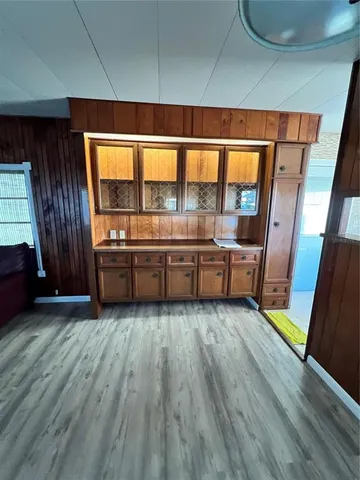 a room with wooden floor and furniture