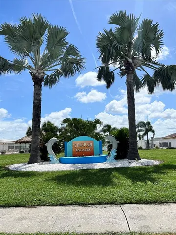 a swimming pool with outdoor seating and yard in back