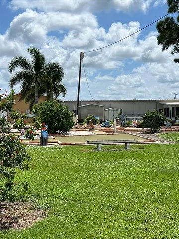 a front view of house with yard and outdoor seating