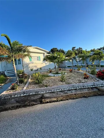 a view of a house with a yard and a street