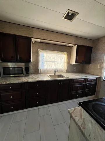 a kitchen with stainless steel appliances granite countertop a sink and a stove