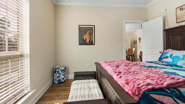 a bed sitting in a bedroom next to a window