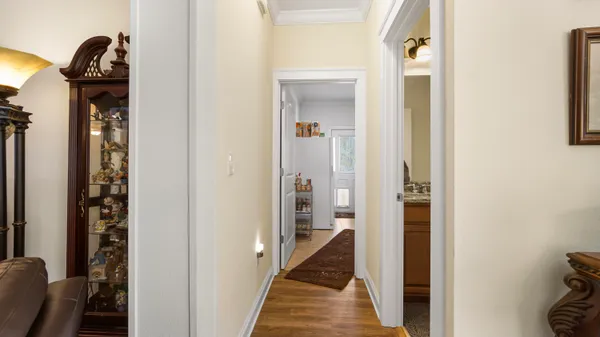 a view of a hallway with a livingroom and a bathroom