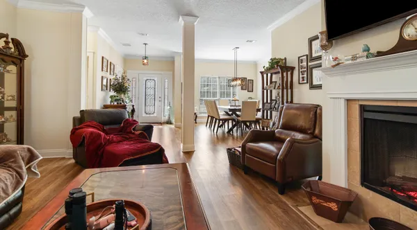 a living room with furniture fireplace and flat screen tv