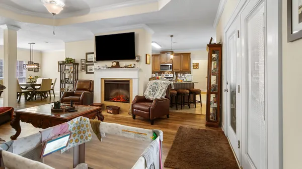 a living room with furniture a fireplace and a flat screen tv