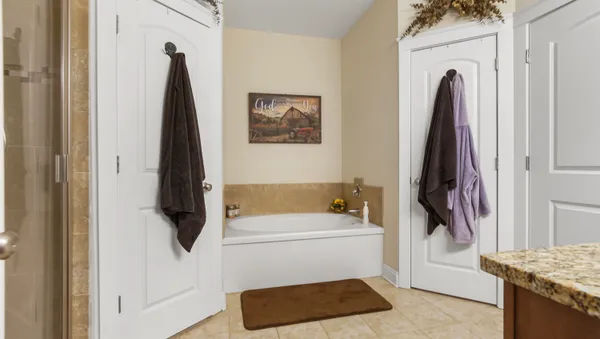 a bathroom with a tub and a walk in closet