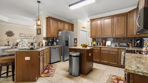 a kitchen with a sink refrigerator and cabinets