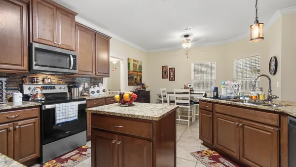 a kitchen with a sink stove top oven and microwave