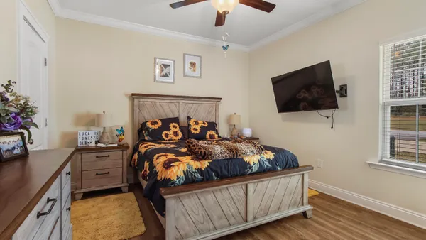 a bed room with furniture and a flat screen tv