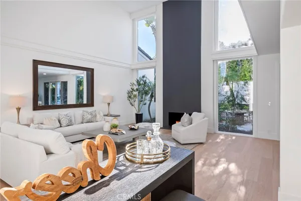 a living room with fireplace furniture and a potted plant