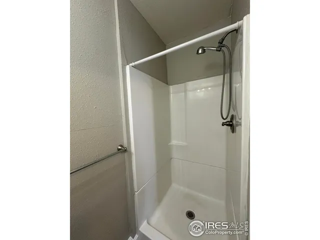 a bathroom with a glass shower door