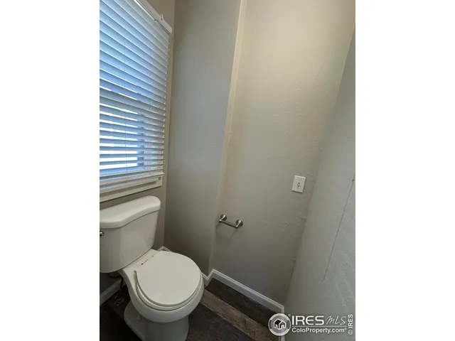a white toilet sitting next to a shower
