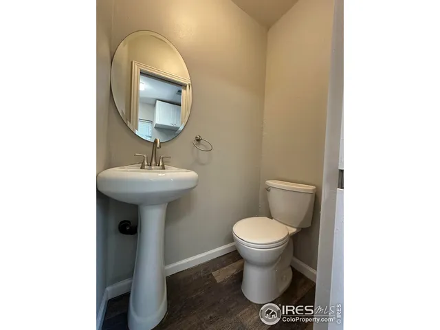 a bathroom with a sink toilet and a mirror