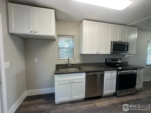 a kitchen with stainless steel appliances granite countertop a sink and a stove