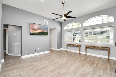 wooden floor in an empty room with a window