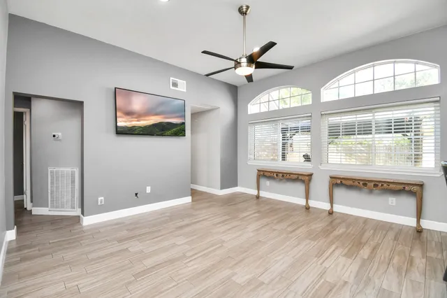 wooden floor in an empty room with a window