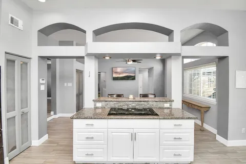 a bathroom with a granite countertop double vanity sink and mirror