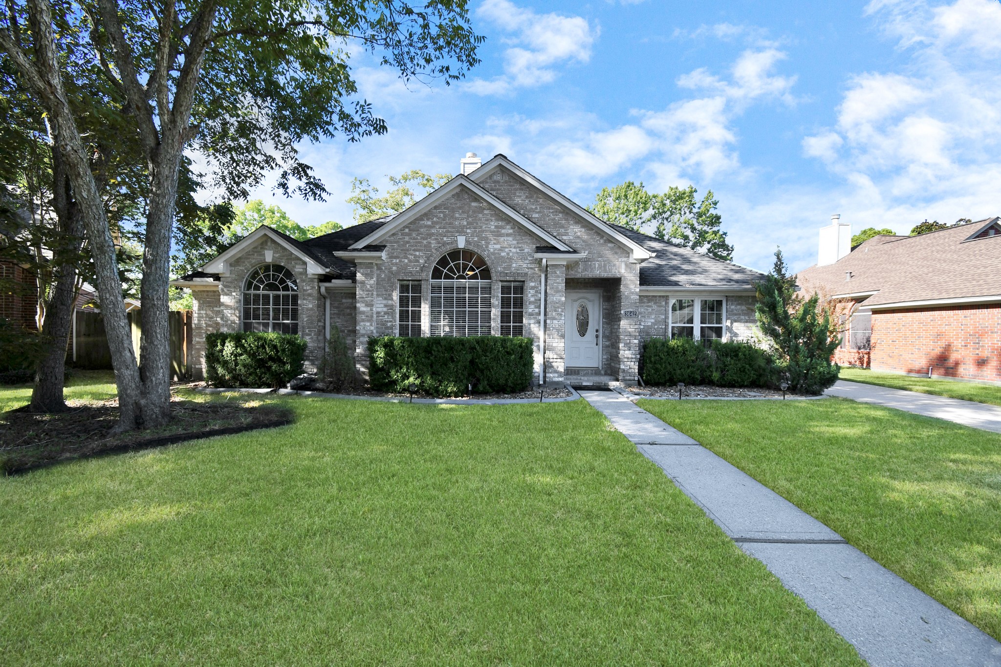 3642 Postwood Drive Spring, TX 77388 - Photo 3 of 43 a front view of a house with a yard and trees