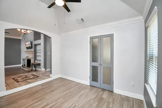wooden floor in an empty room with a window