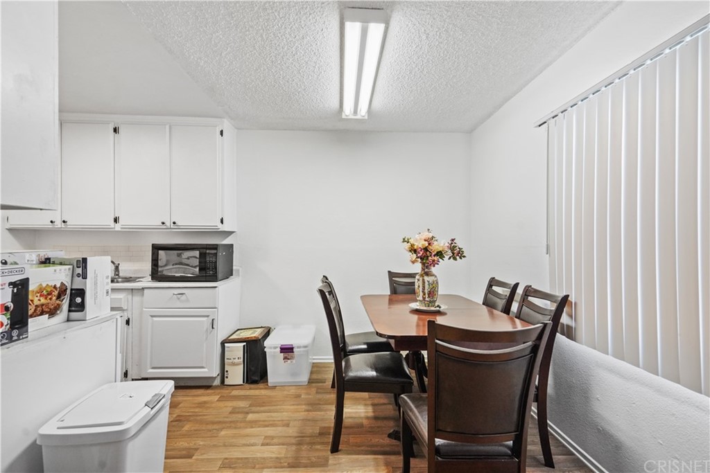 14607 Gilmore Street Van Nuys, CA 91411 - Photo 7 of 9 a view of a dining room with furniture and a kitchen