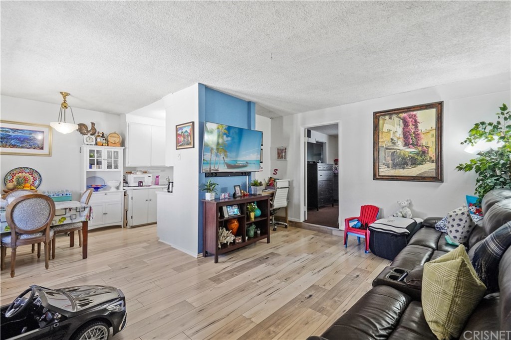14607 Gilmore Street Van Nuys, CA 91411 - Photo 8 of 9 a living room with furniture and a wooden floor