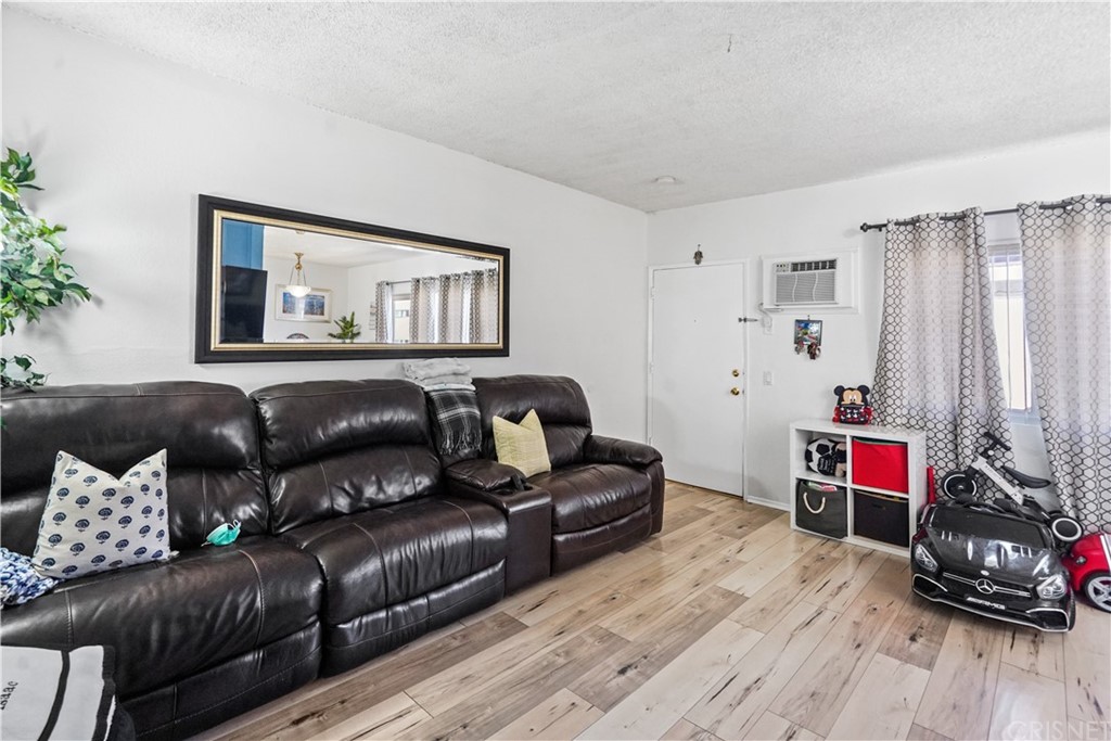 14607 Gilmore Street Van Nuys, CA 91411 - Photo 9 of 9 a living room with furniture and a wooden floor