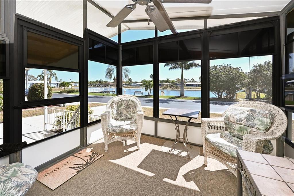 a living room with furniture and a floor to ceiling window