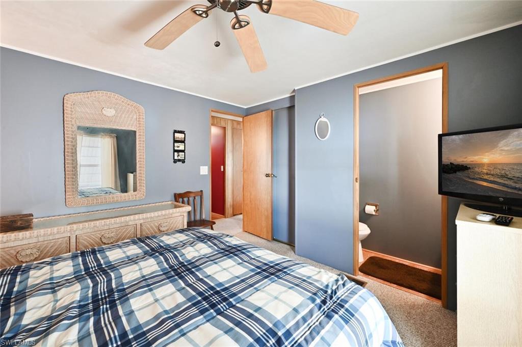 192 Oceans Boulevard, Unit 192 Naples, FL 34104 - Photo 11 of 26 a bedroom with a bed and a flat screen tv