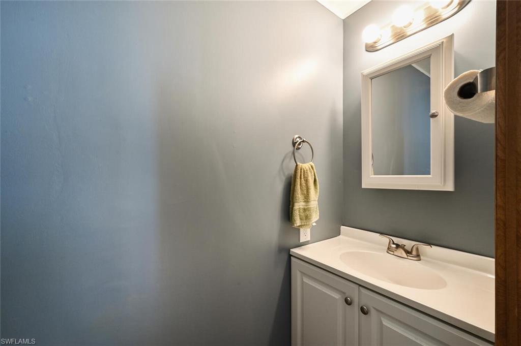 192 Oceans Boulevard, Unit 192 Naples, FL 34104 - Photo 12 of 26 a bathroom with a sink and a mirror