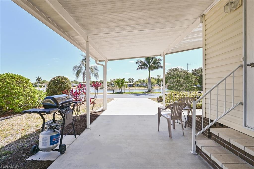 192 Oceans Boulevard, Unit 192 Naples, FL 34104 - Photo 16 of 26 a view of a patio with a table and chairs