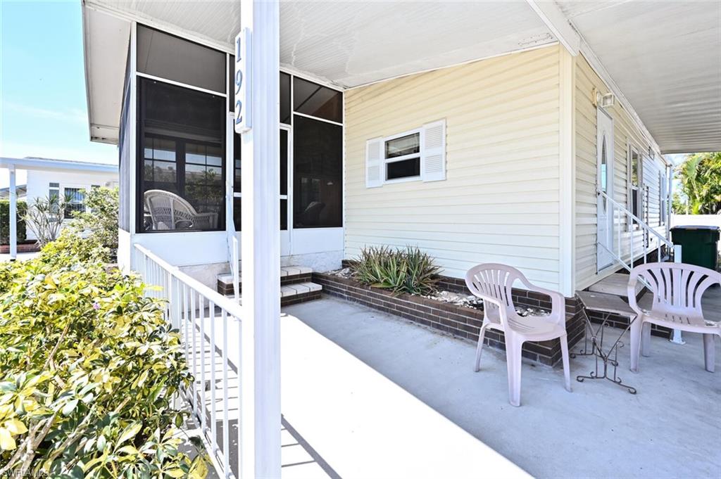 192 Oceans Boulevard, Unit 192 Naples, FL 34104 - Photo 17 of 26 a balcony with table and chairs