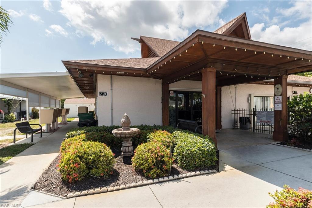 192 Oceans Boulevard, Unit 192 Naples, FL 34104 - Photo 24 of 26 a front view of a house with garden