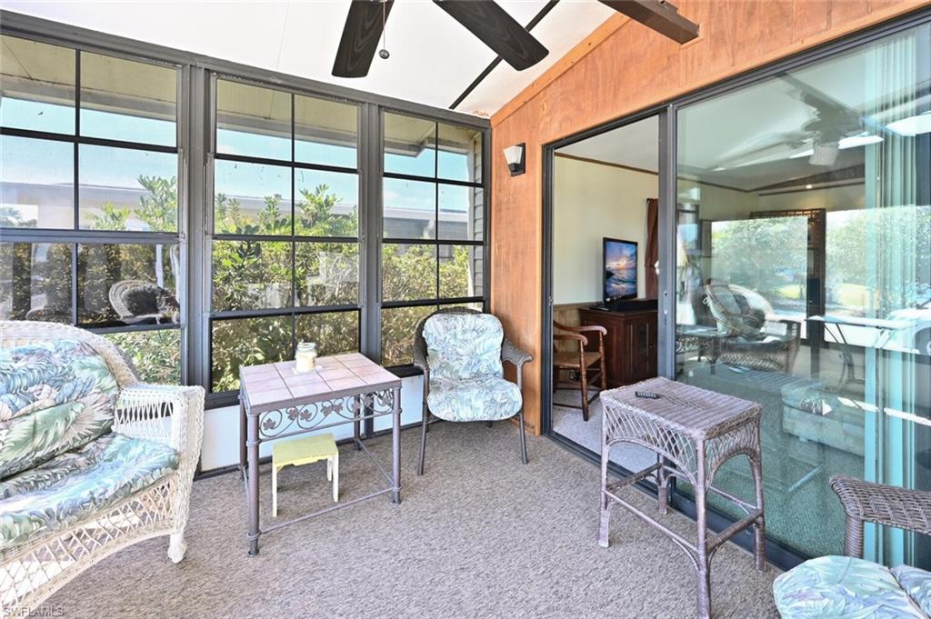 192 Oceans Boulevard, Unit 192 Naples, FL 34104 - Photo 4 of 26 a living room with furniture and a floor to ceiling window