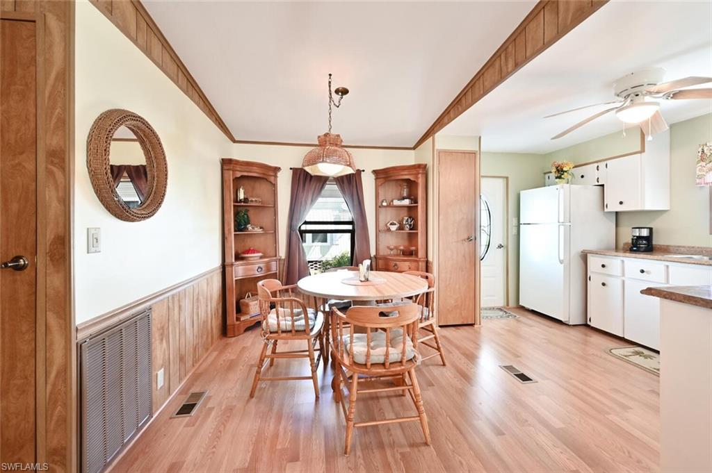 192 Oceans Boulevard, Unit 192 Naples, FL 34104 - Photo 7 of 26 a view of a dining room with furniture window and wooden floor