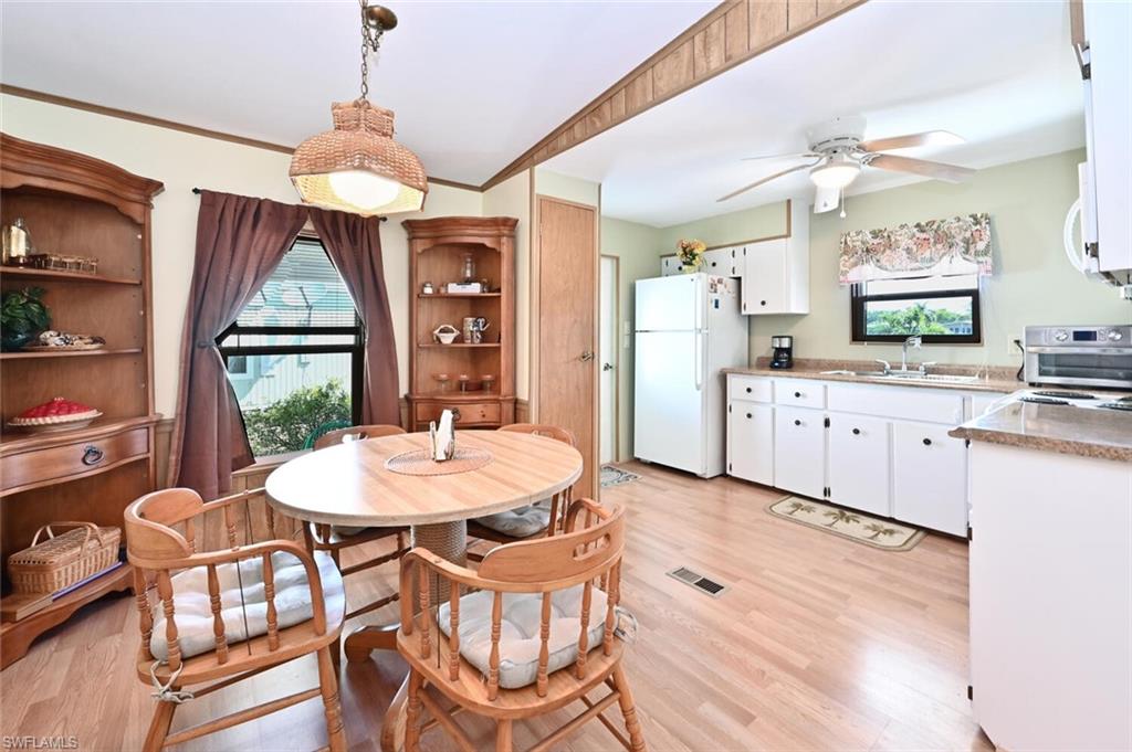 192 Oceans Boulevard, Unit 192 Naples, FL 34104 - Photo 8 of 26 a kitchen with stainless steel appliances a dining table chairs and chandelier