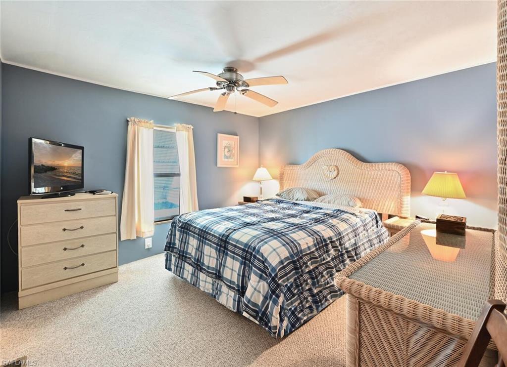192 Oceans Boulevard, Unit 192 Naples, FL 34104 - Photo 10 of 26 a bedroom with a bed and a flat screen tv