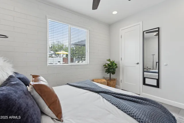 a bedroom with bed and a window