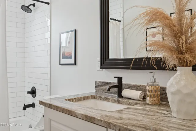 a bathroom with a sink and a mirror