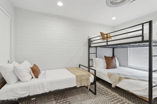 a bedroom with a bed and chair