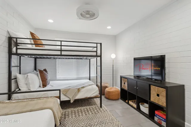 a bedroom with furniture and a flat screen tv