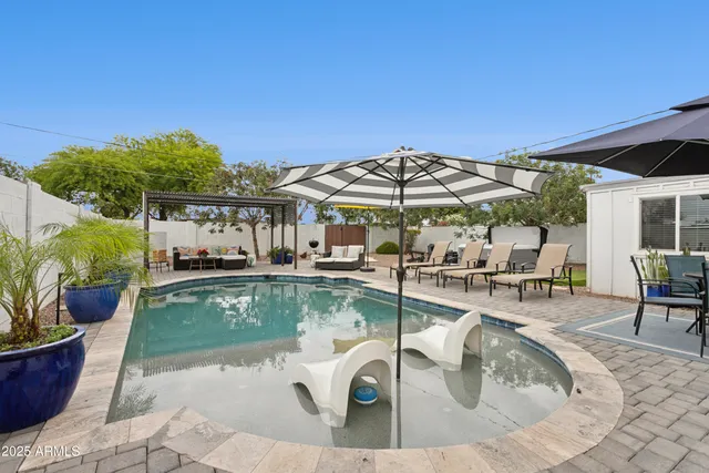 a view of a swimming pool with sitting area