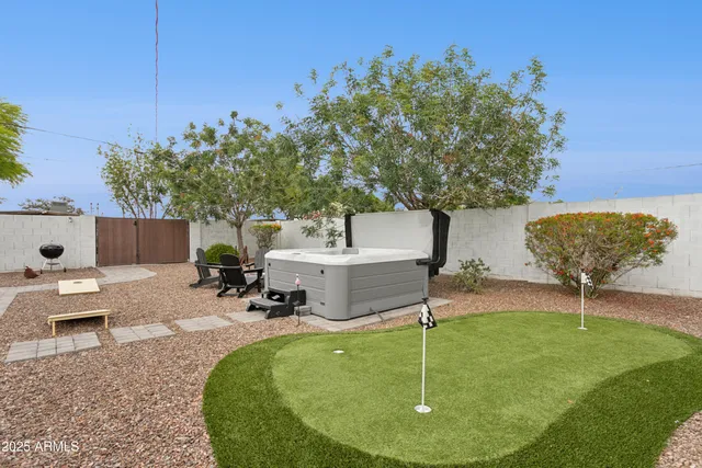 a backyard of a house with table and chairs