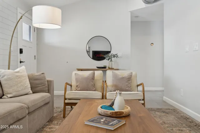a living room with furniture and a mirror