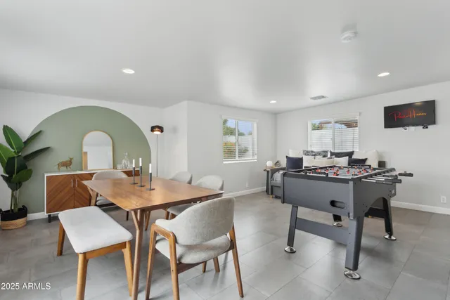 a view of a dining room with a table and chairs