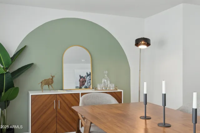 a view of a dining room with a table and chairs