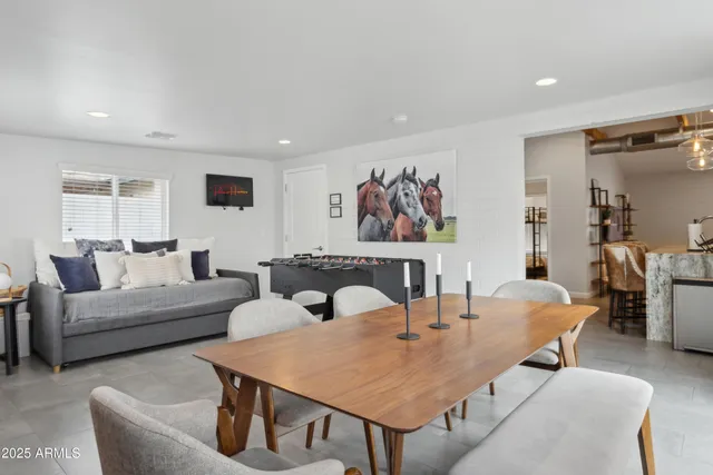 a living room with furniture a rug and a table