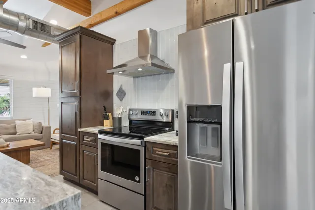 a kitchen with stainless steel appliances a refrigerator sink and stove