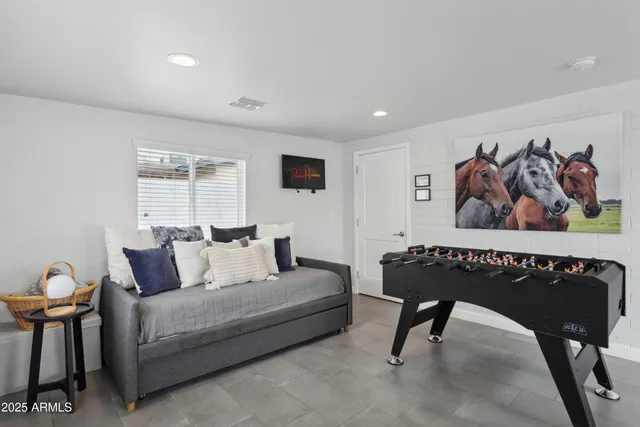 a living room with furniture a rug and a window