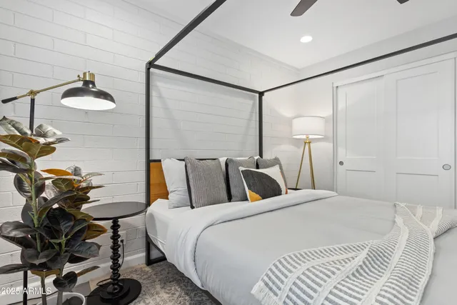 a bedroom with a bed and chandelier